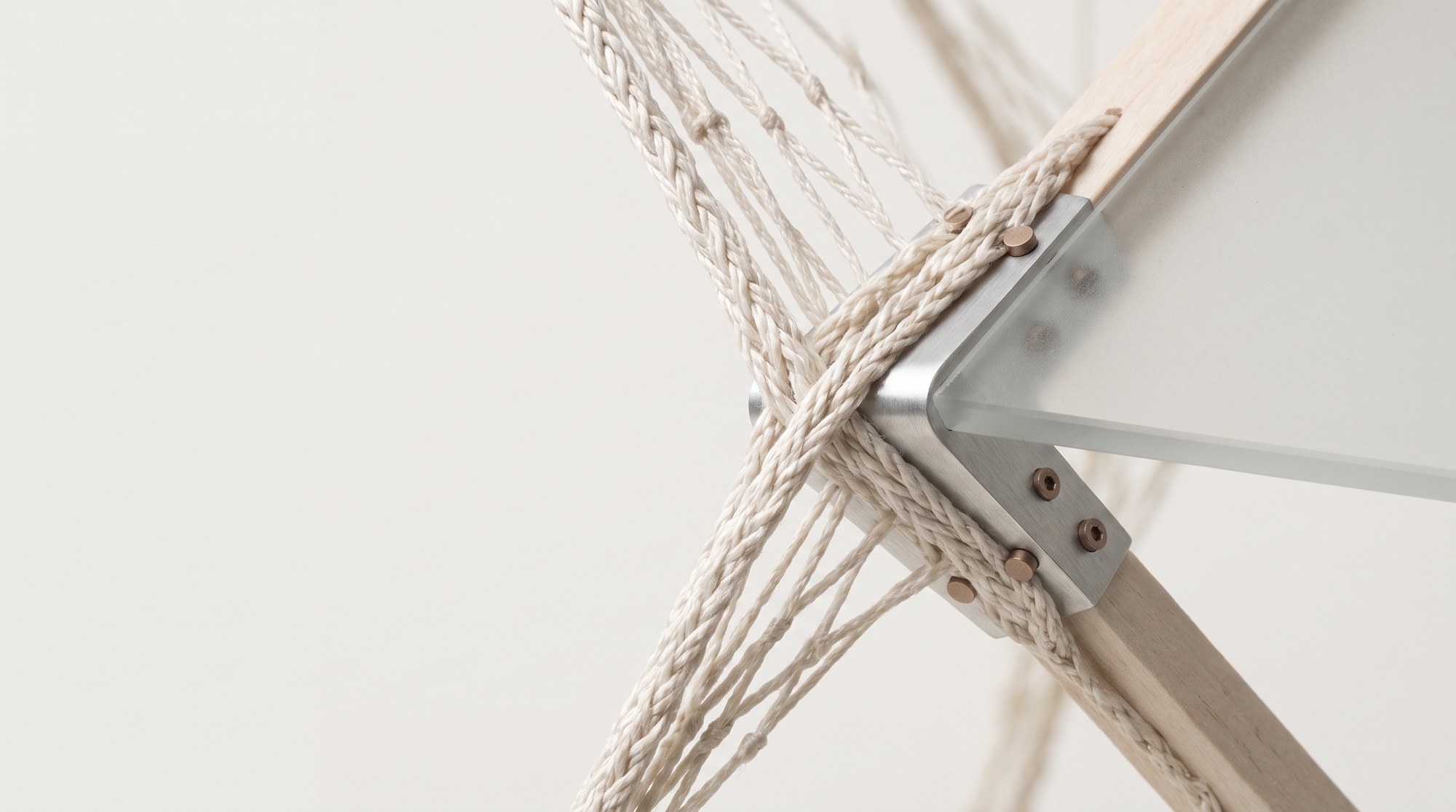 Interpretive junction of recovered braided net, brushed metal and translucent panel